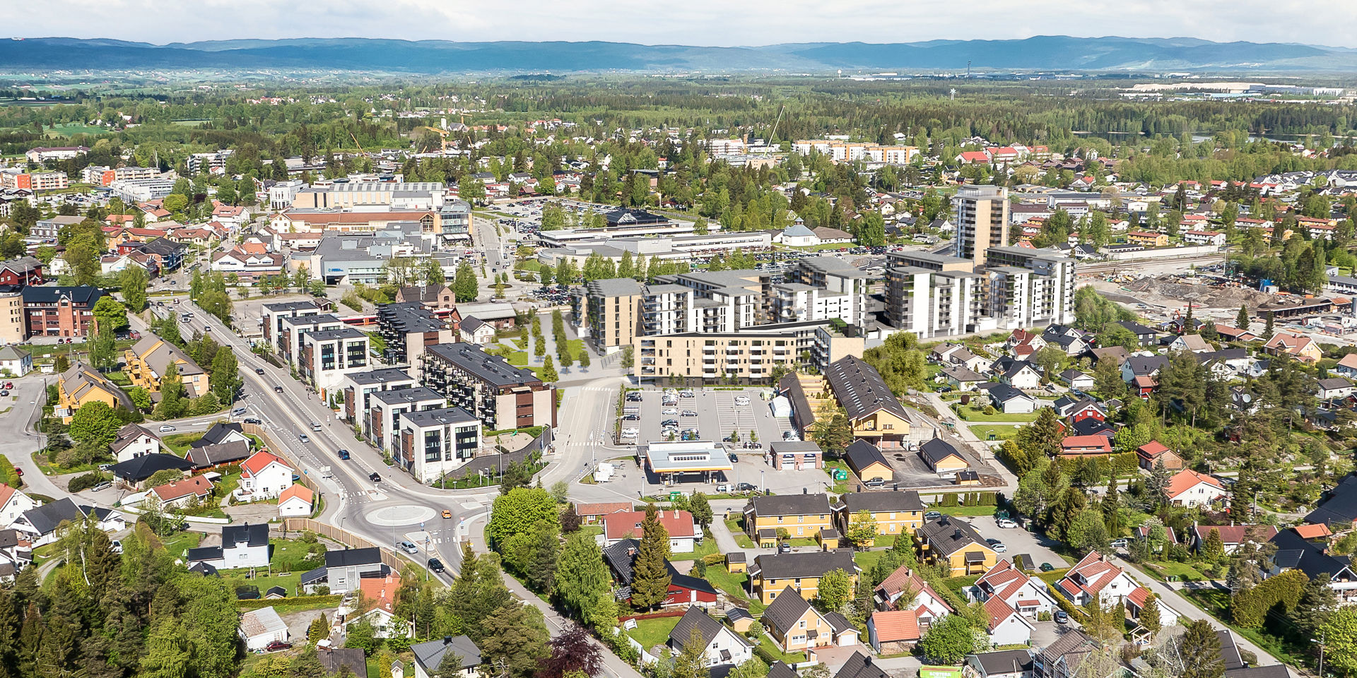 dronebilde over tettbebygd strøk med illustrasjonre av nye bygg